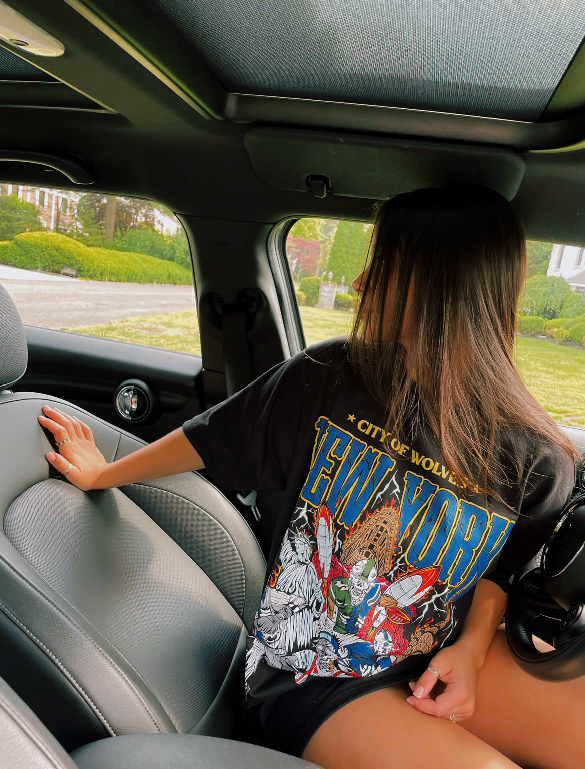 Female model in car wearing Lord Wolf's New York Graphic Tee